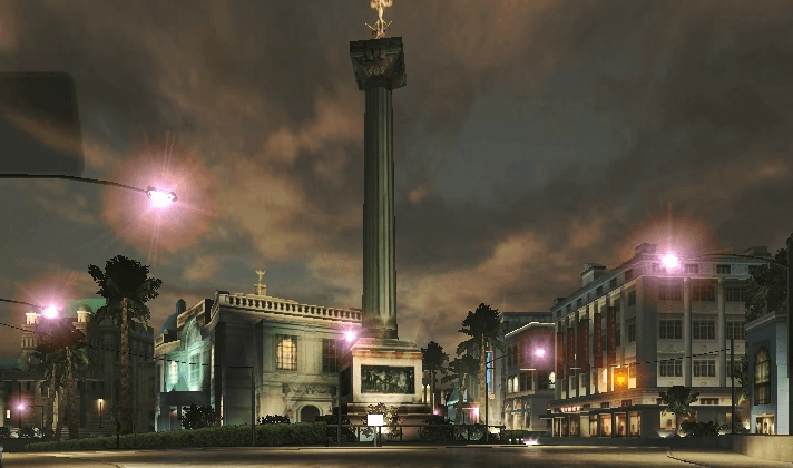 Night street scene in Bayview from Need for Speed Underground 2, with a lit column monument and neon-lit buildings